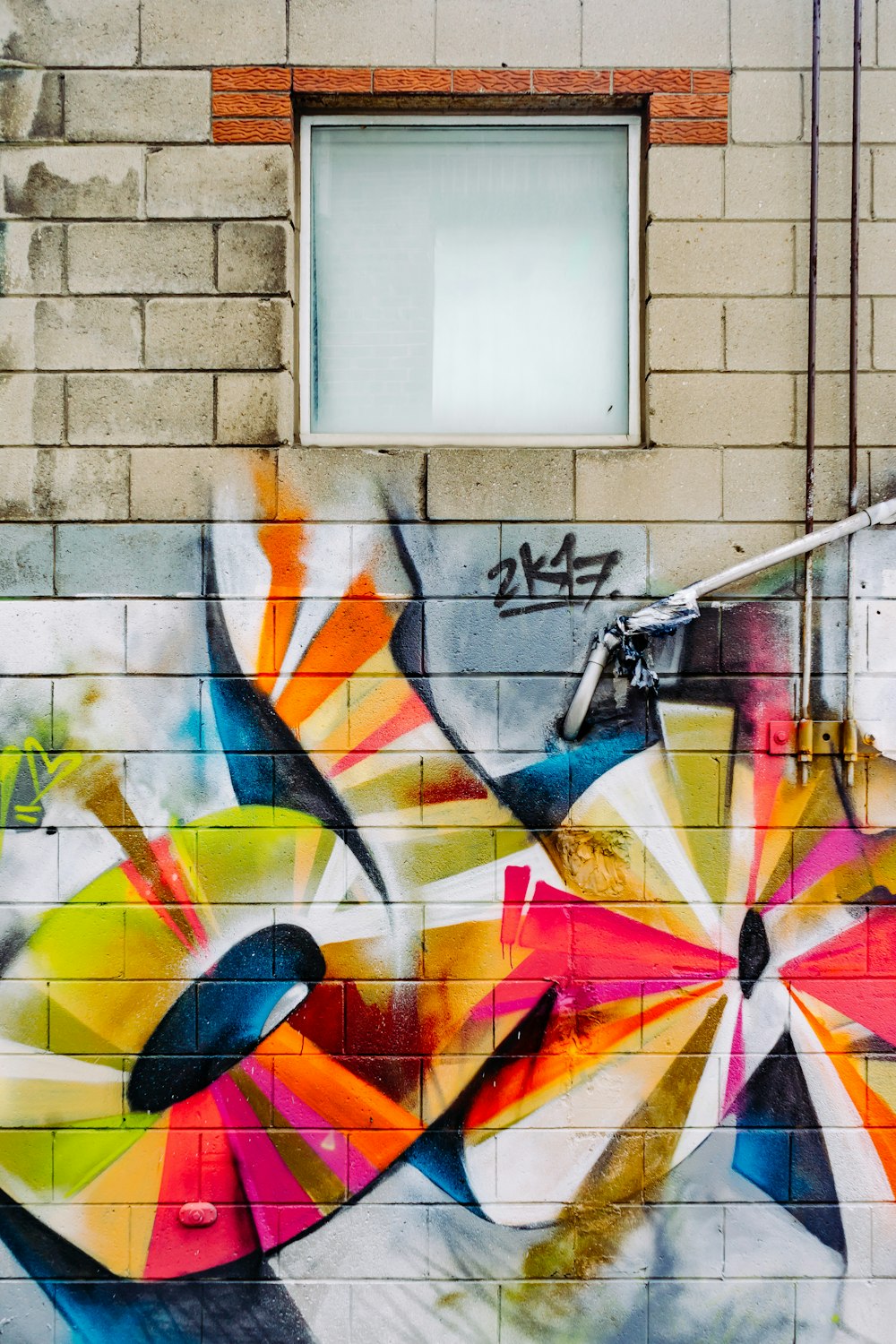 photo of orange, red, and yellow graffiti printed wall