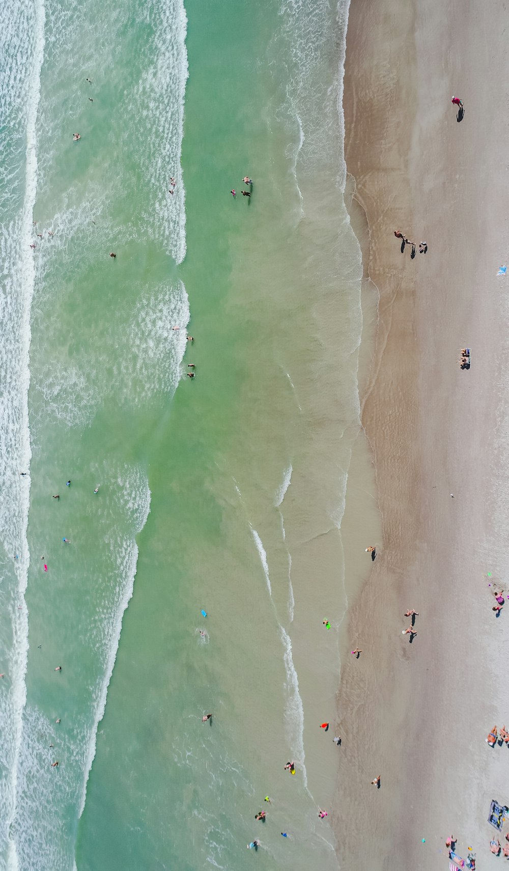people at the beach during daytime aerial photography