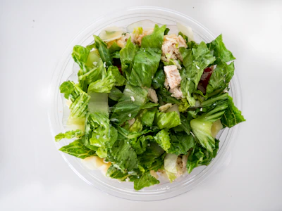 Freshly prepared chicken salad with vibrant greens and colorful veggies