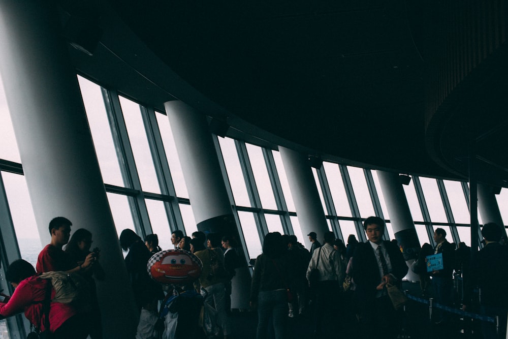 a group of people standing in a large building