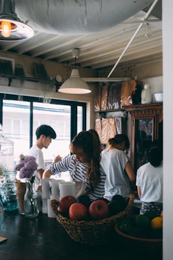 A warm Scandinavian-style kitchen scene with fresh local ingredients and a team planning social media content.