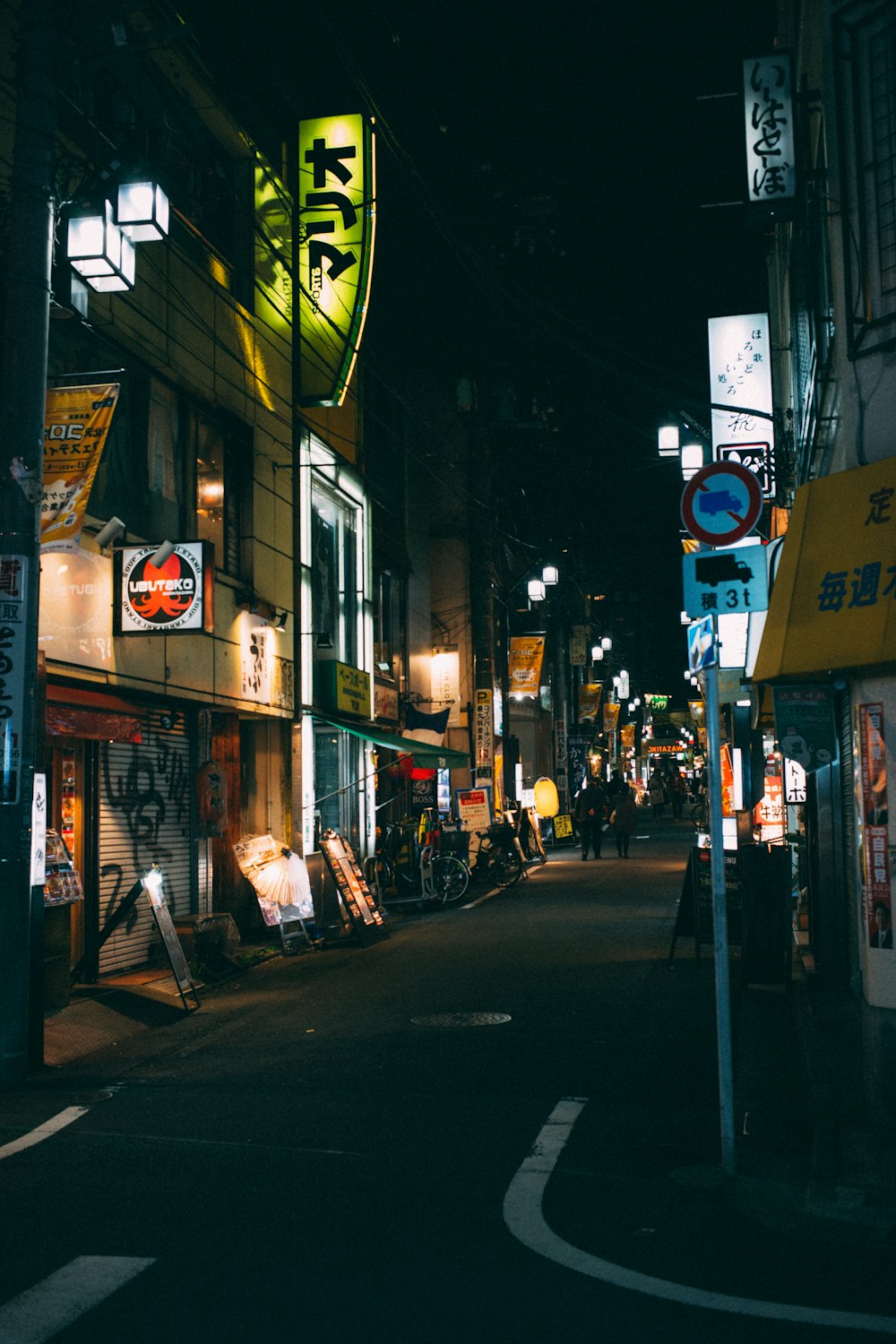 people walking between buildings