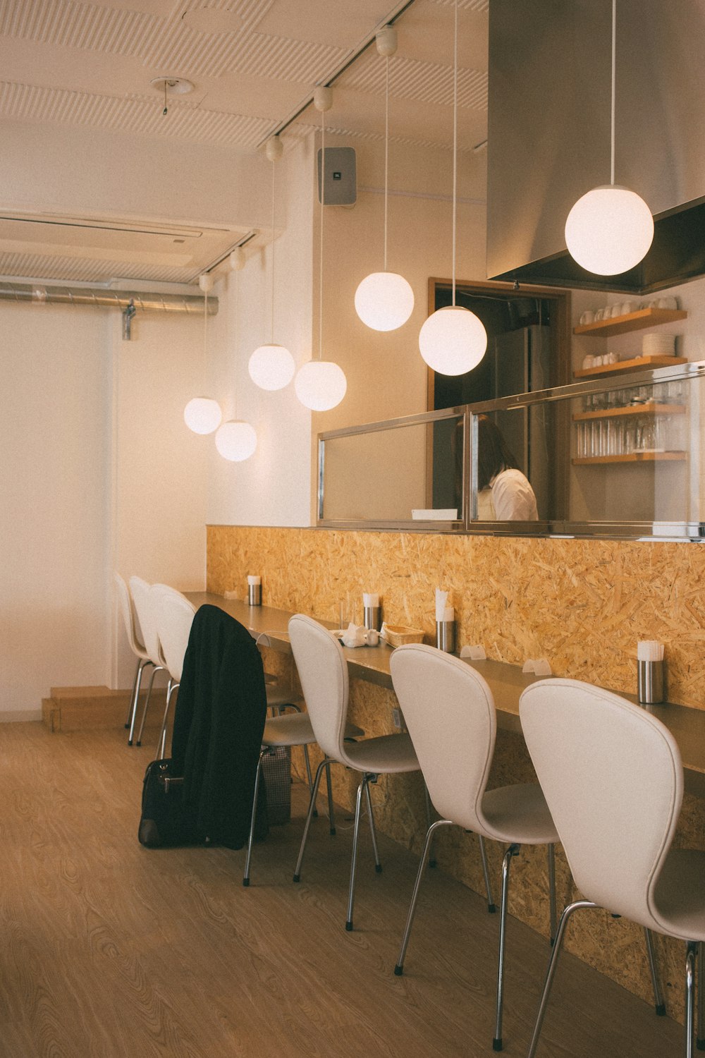 a long table with white chairs in a room