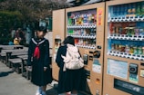 Children happily choosing fresh beverages and nutritious snacks from a smart vending machine at a school.