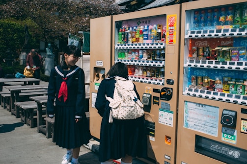 Students happily choosing fresh snacks from a smart vending machine in a school hallway.