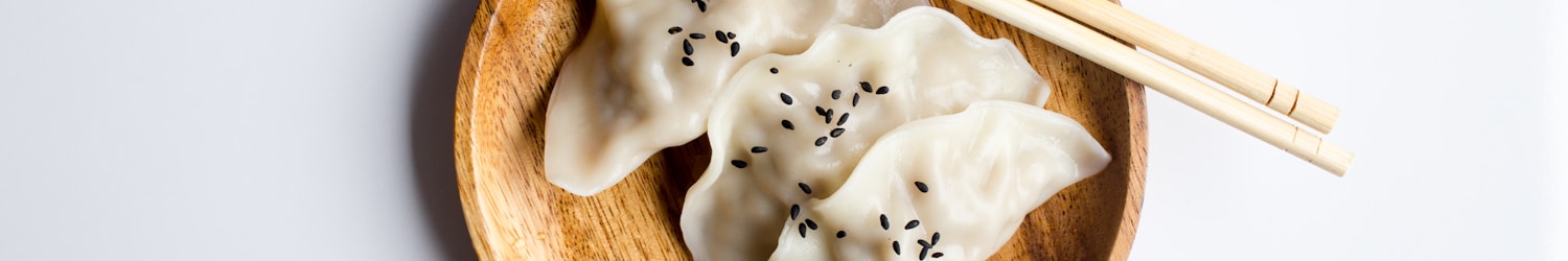 three white dimsum on brown bowl