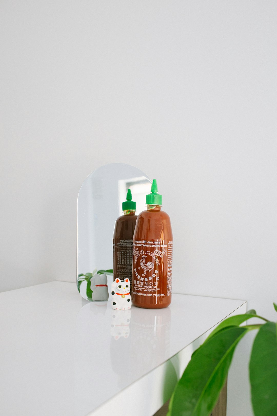 orange labeled plastic squeeze bottle on white surface