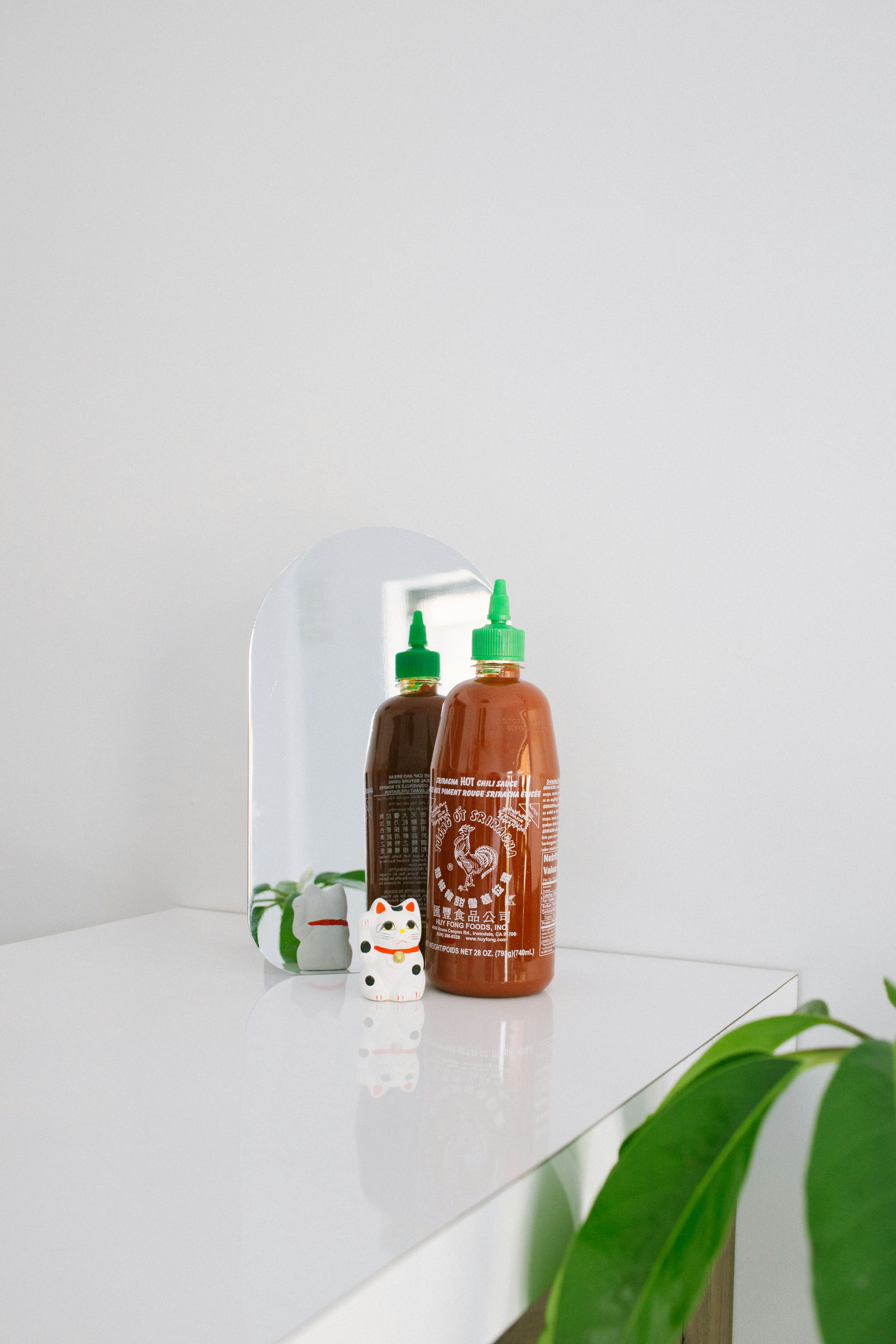 orange labeled plastic squeeze bottle on white surface