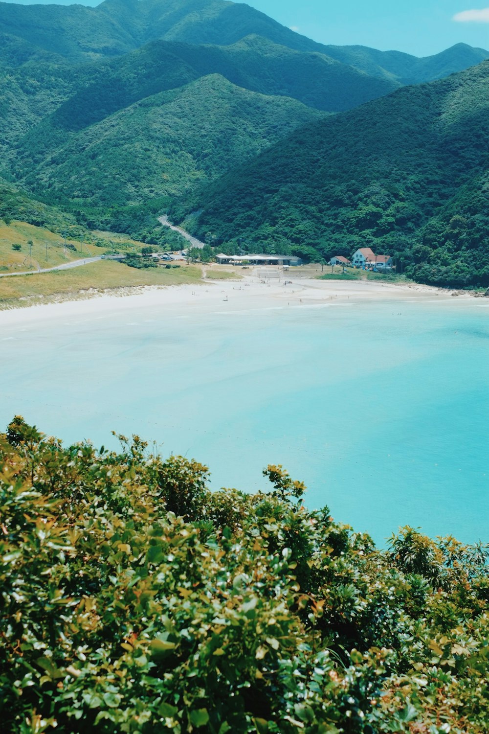 calm blue body of water surrounded by mountains