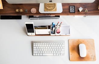 white Apple mouse beside keyboard