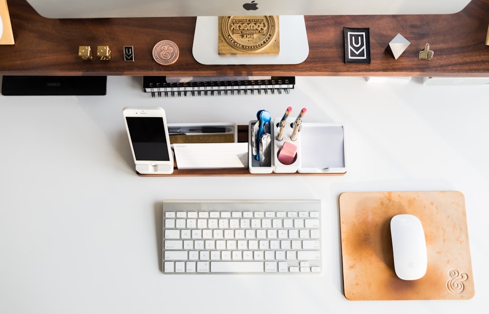 white Apple mouse beside keyboard