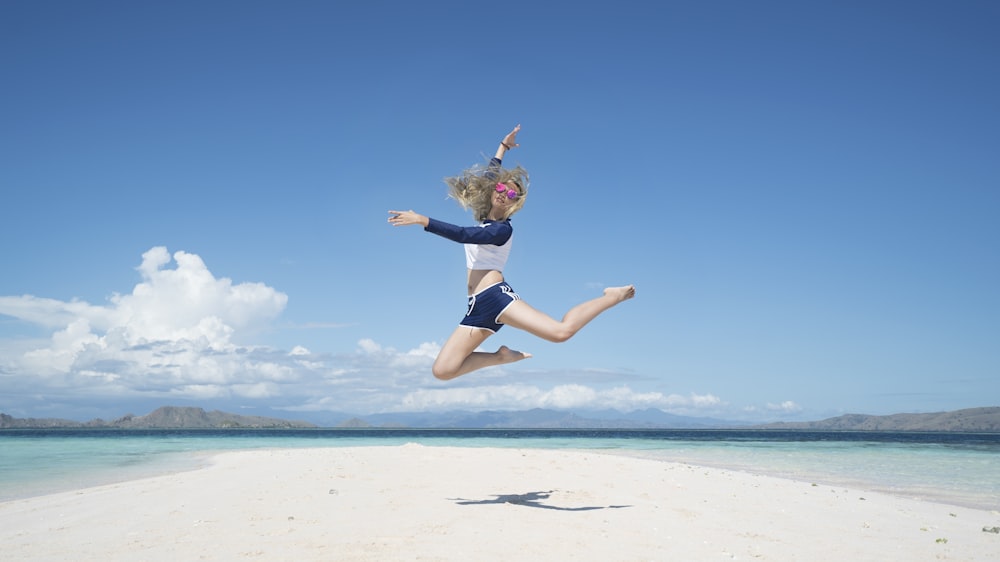 woman jumping with raising her right hand