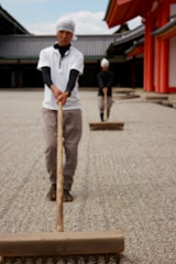Workers spreading stones evenly over a dug-out area in Kuwait.