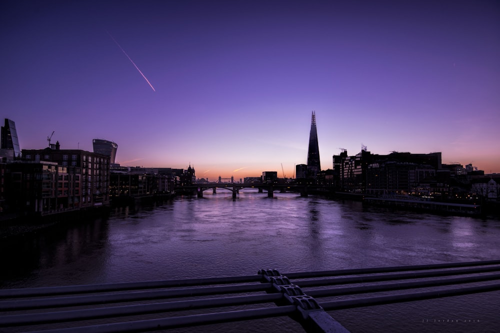 silhouette of buildings beside body of water