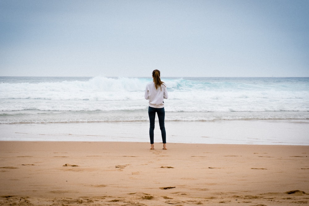 woman standing near seashore during daytime