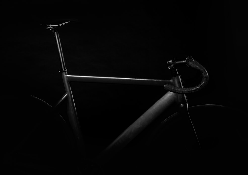 black road bike on against black background