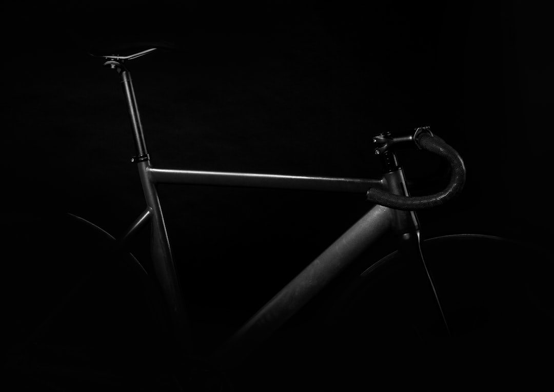 black road bike on against black background,