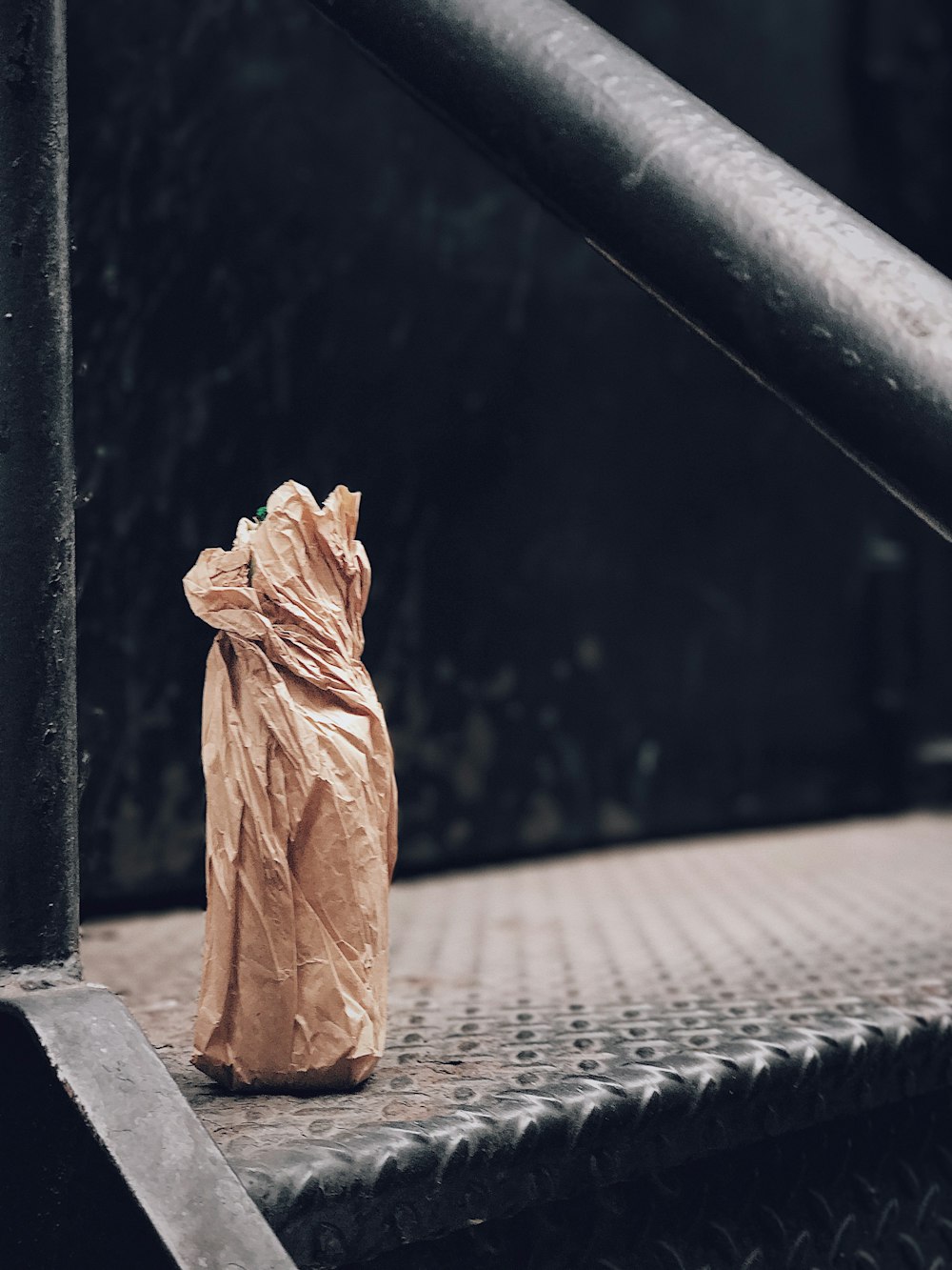 brown paper bag on stairs