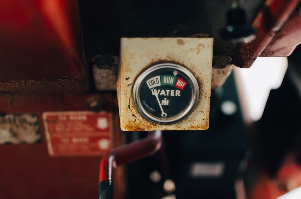 selective focus photography of white water gauge