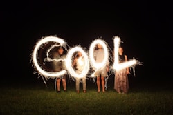 fun image of four people holding fireworks and forming the word cool