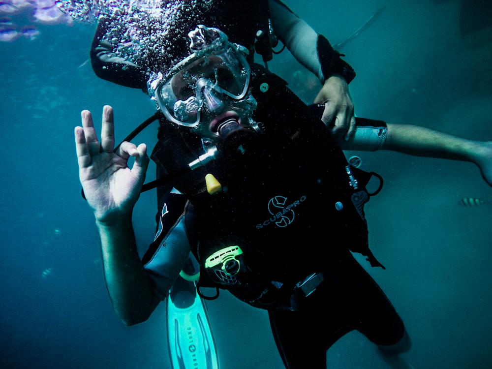 person wearing diving suit under water