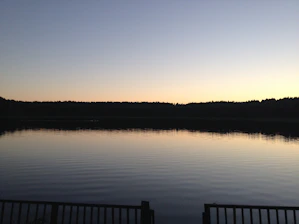 A serene lakeside scene at sunset symbolizing calm and transition.