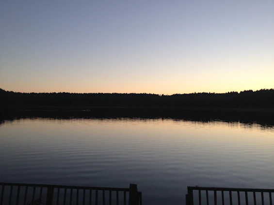 A serene lakeside scene at sunset symbolizing calm and transition.