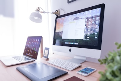 Strony internetowe olsztyn - silver iMac near iPhone on brown wooden table