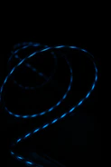 3D rotating axial flux motor with glowing electric blue accents against a dark background.