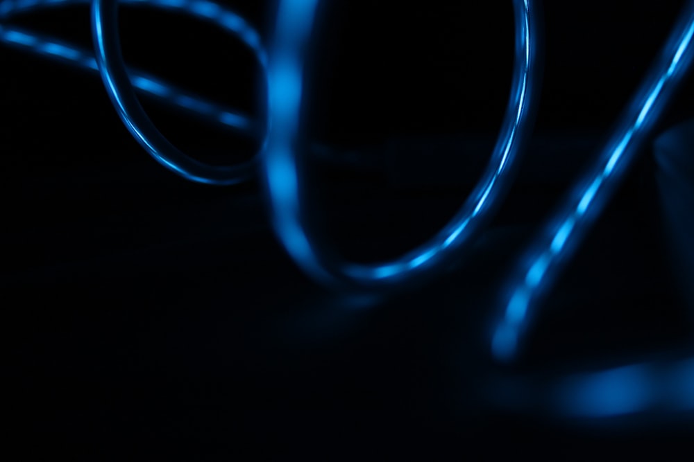 Blue light reflected in the surface of glossy swirling wires