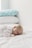 photo of baby laying on bed
