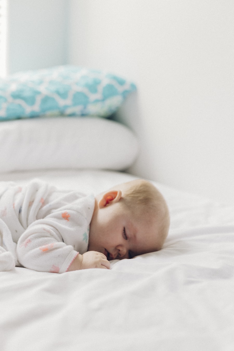 Baby peacefully laying on a bed, illustrating the four month sleep regression