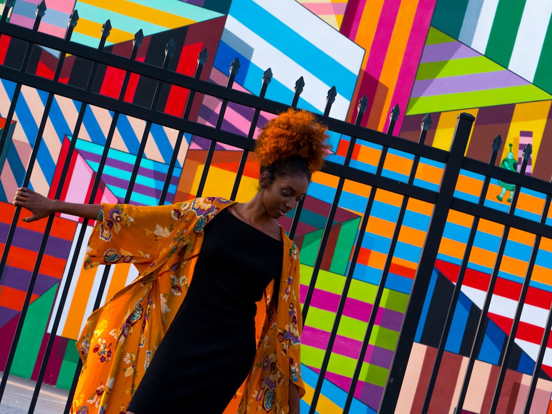 woman standing in front of black gate