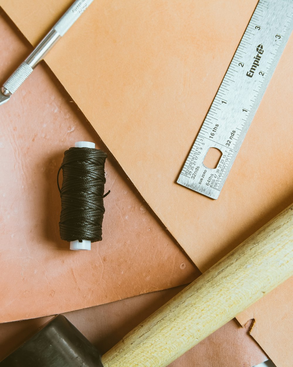 closeup photo of ruler and thread