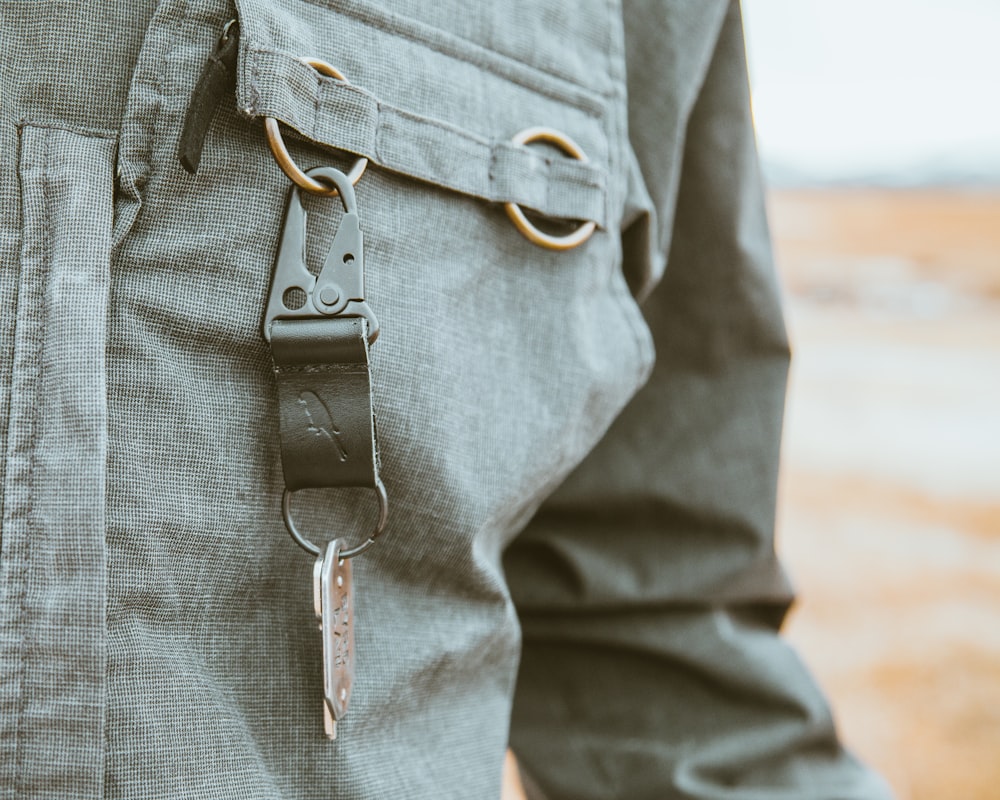 a person wearing a belt and a pair of scissors