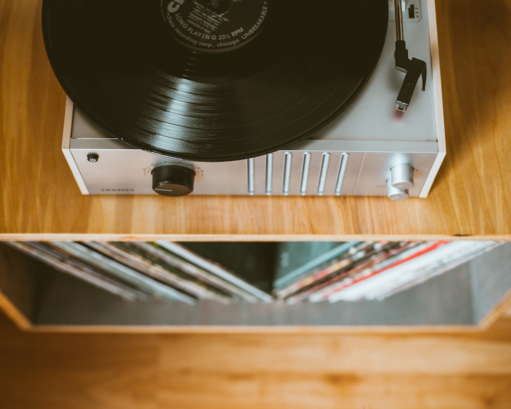 gray turntable on brown wooden table