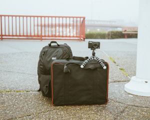 camera mounted on tripod on top of luggage bag