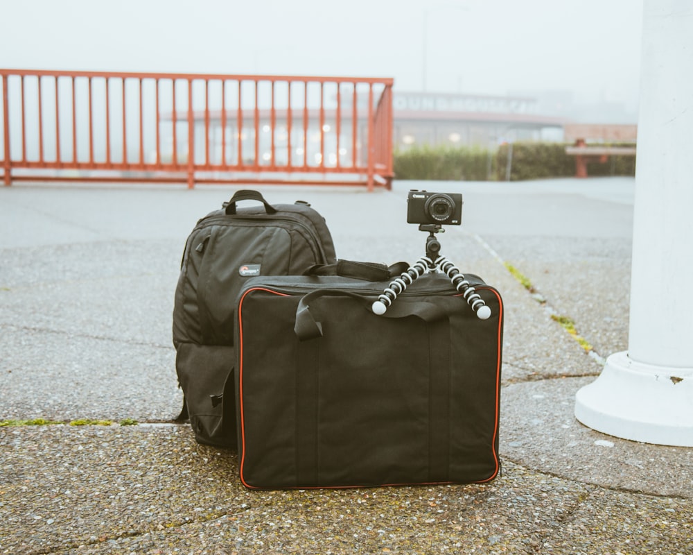 camera mounted on tripod on top of luggage bag