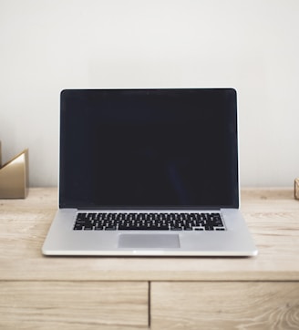 MacBook Pro on top of brown table