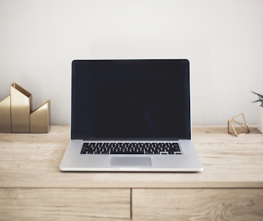 MacBook Pro on top of brown table