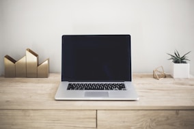 MacBook Pro on top of brown table