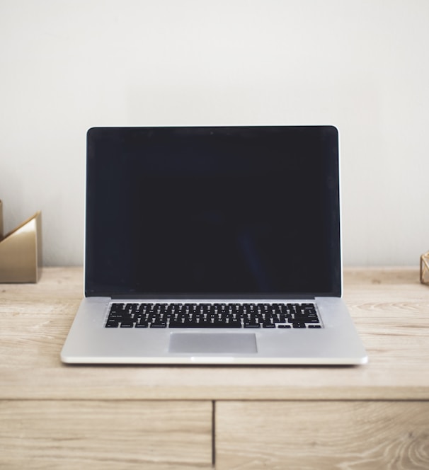 MacBook Pro on top of brown table