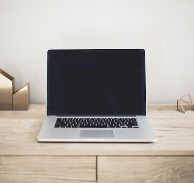 MacBook Pro on top of brown table