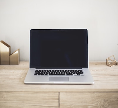 MacBook Pro on top of brown table