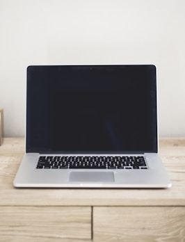 MacBook Pro on top of brown table