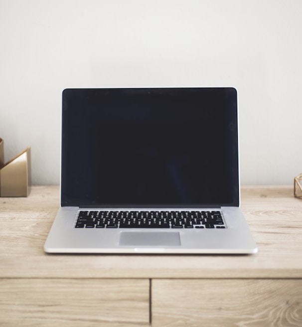 MacBook Pro on top of brown table