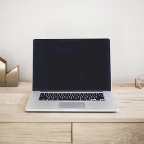 MacBook Pro on top of brown table