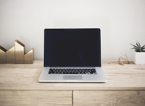 MacBook Pro on top of brown table