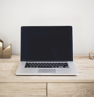 MacBook Pro on top of brown table