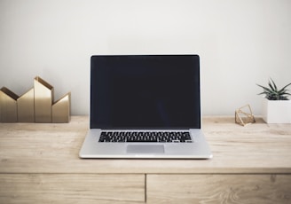 MacBook Pro on top of brown table